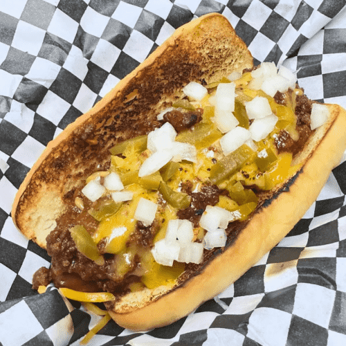 Chili dog with cheese, onions, and jalapenos